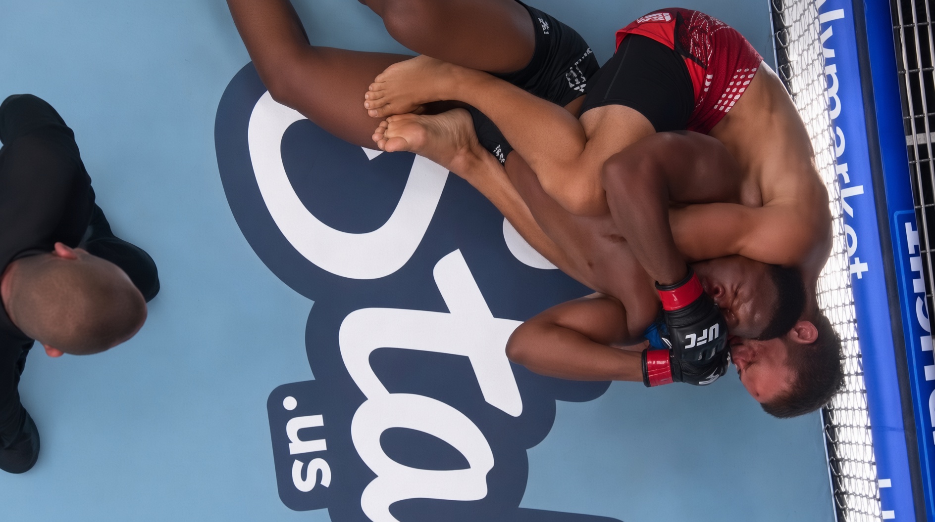 The rear-naked choke sinking in under full arena lights