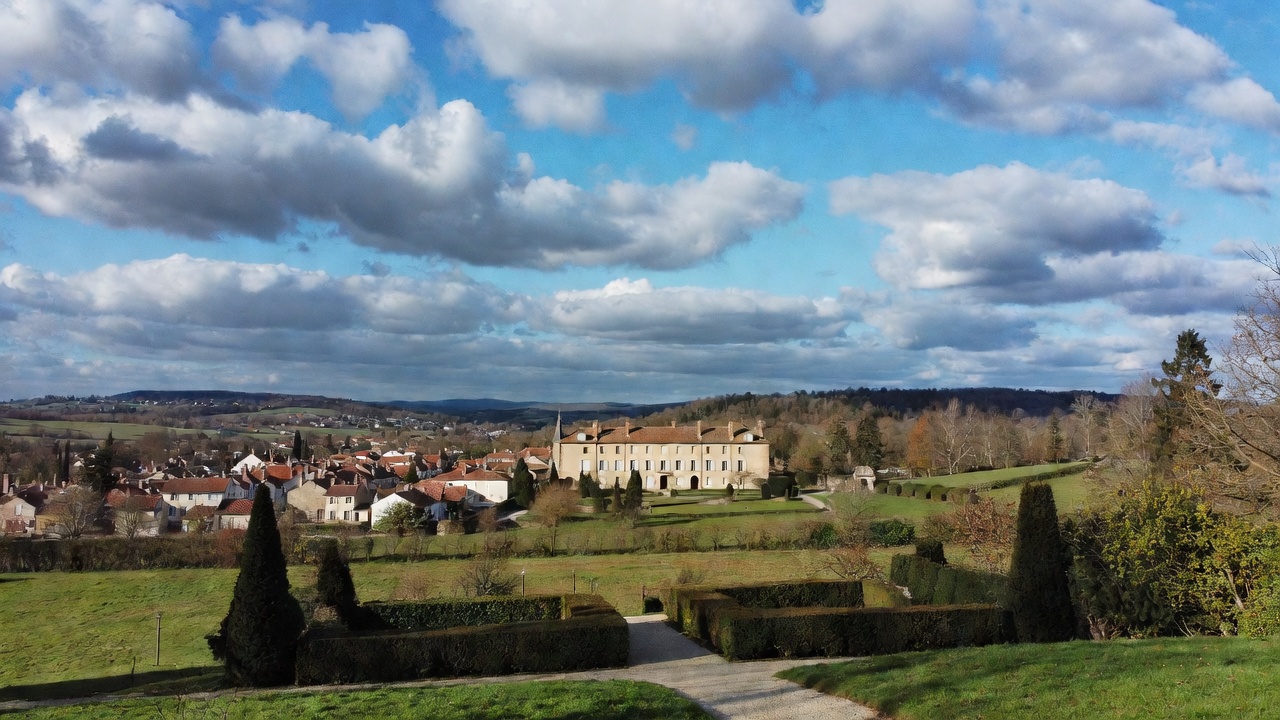 The chateau at Ferney above the village and its clipped gardens